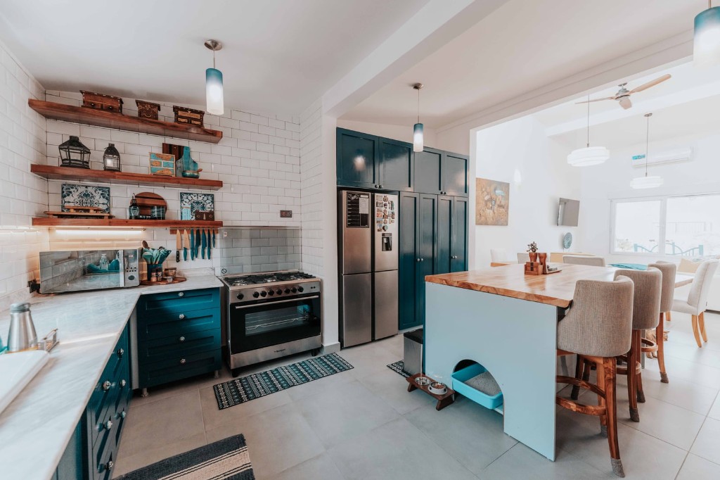Immaculate modern kitchen with navy cabinets and marble countertops